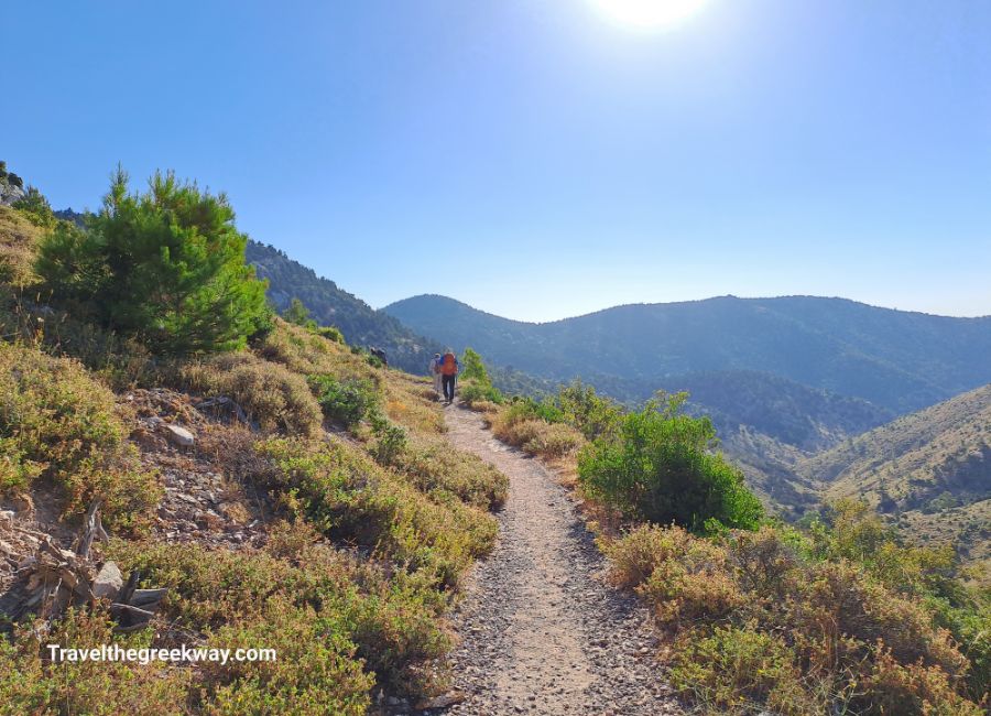Two hikers on a trail on a mountain Panritha in Athens Greece.