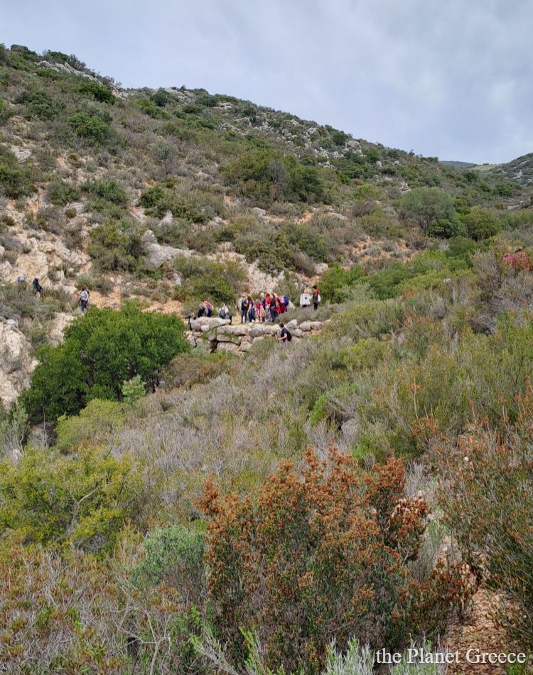 Hikers on top of a Mycenaean bridge in the Peloponnese Greece.