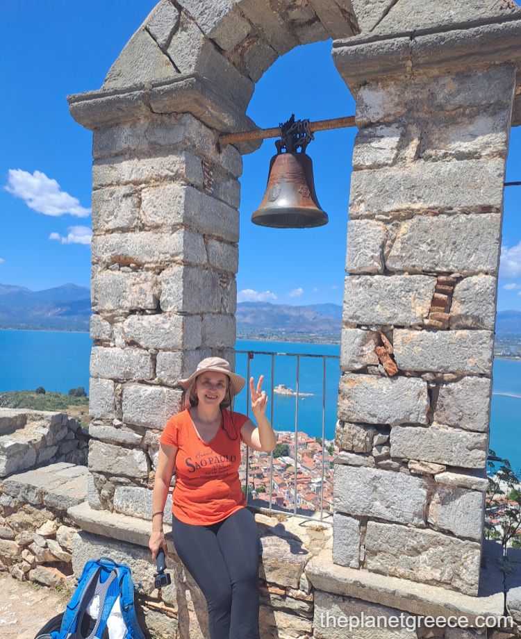 A woman smiling in palamidi in Nafplio Greece.