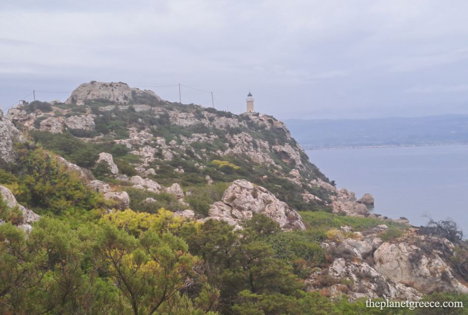 View of Melagkavi Lighthouse on a rocky hill overlooking the Gulf of Corinth in Loutraki, Greece.